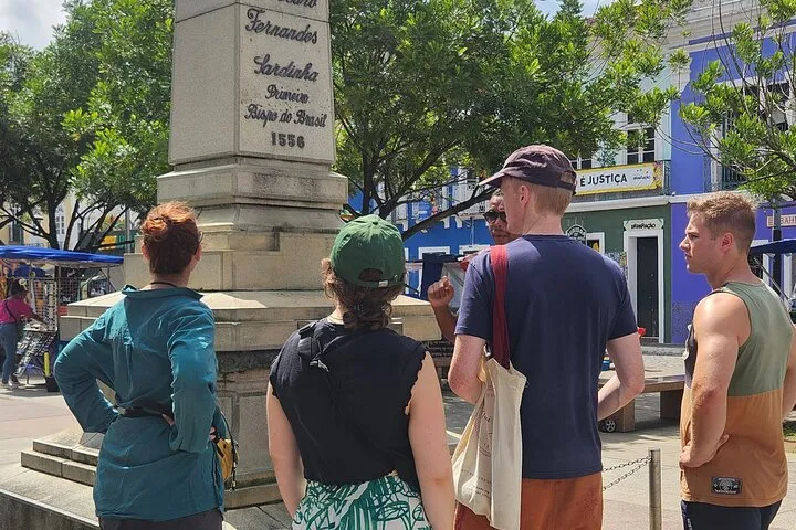 A group of travelers listening to our guide in the historic center