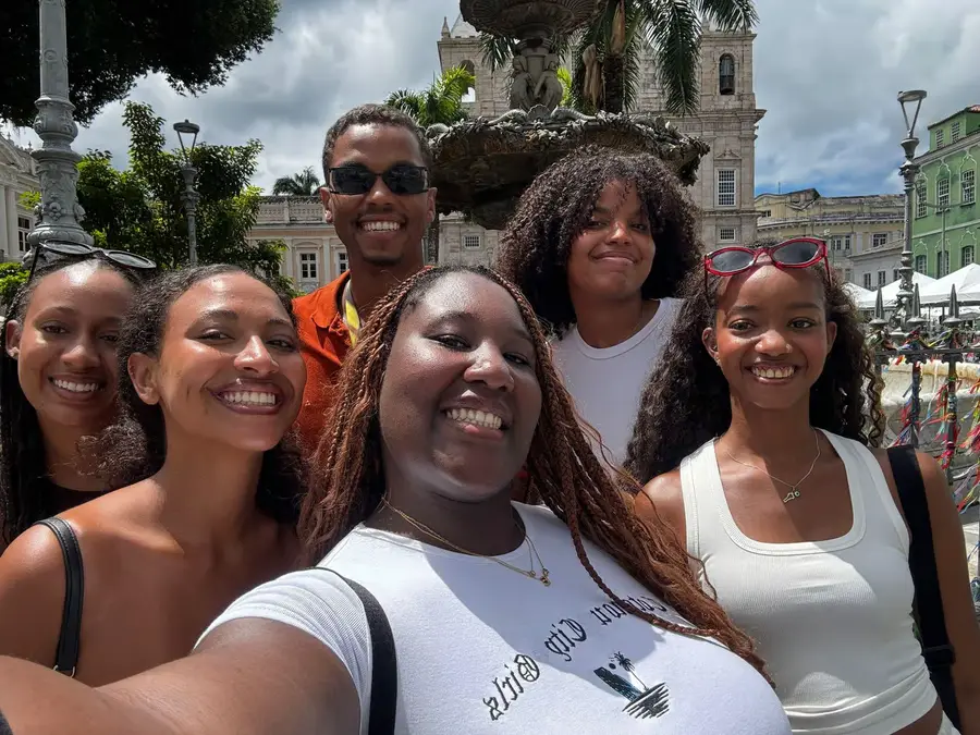 Adriano with a group of smiling travelers in Terreiro de Jesus