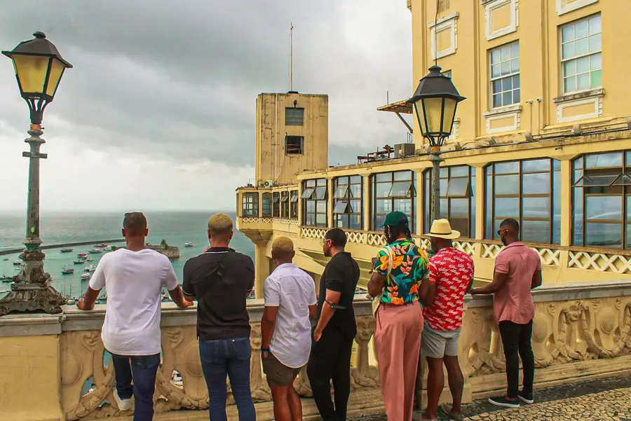 A group of travelers looking out over the Bay of All Saints next to the Lacerda Elevator